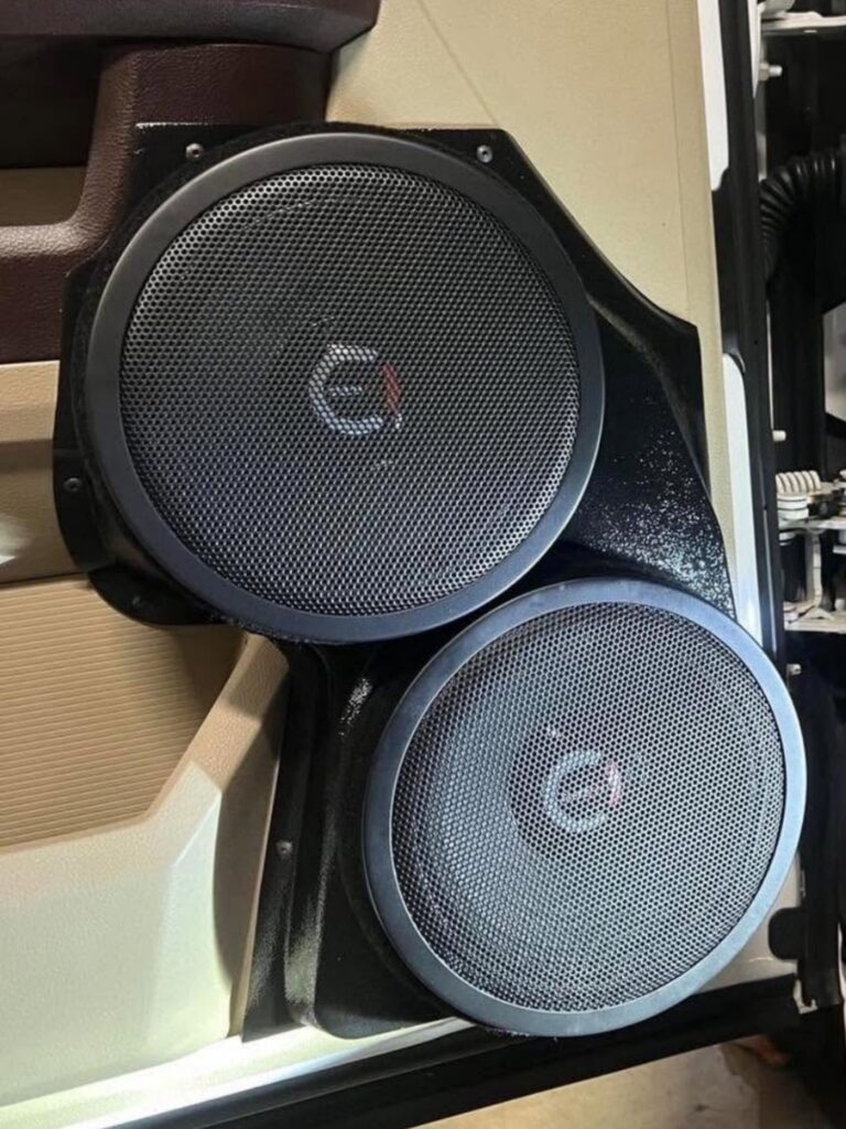 dual 8 inch speaker pods installed with speakers on a dodge ram door panel.